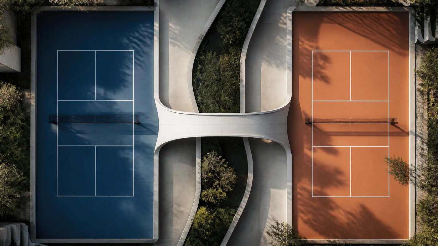 Aerial view of two pickleball courts, one blue and one orange, joined by an elegant architectural bridge